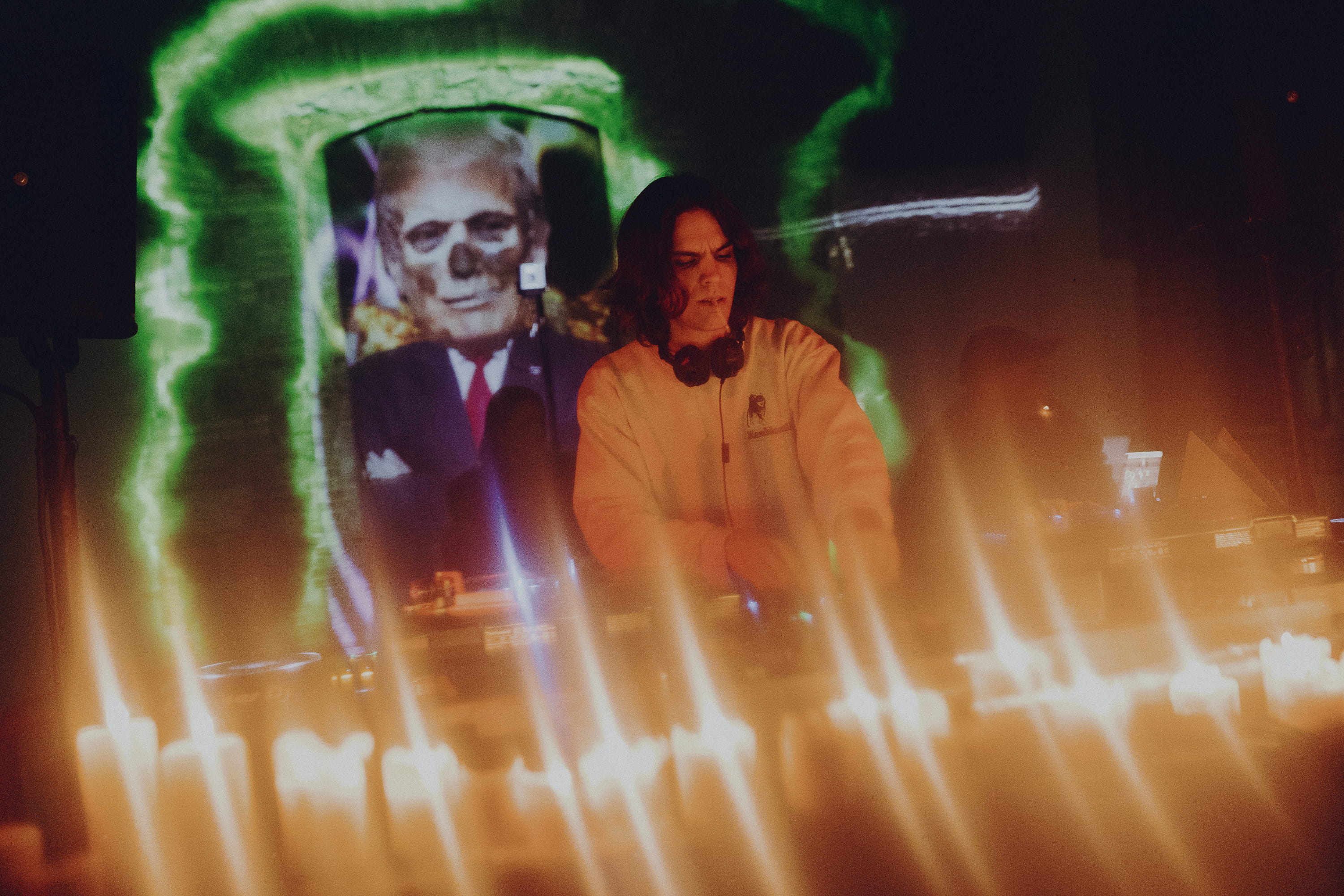 Hiker in Blue Gear Looking Up at Mountain Sky