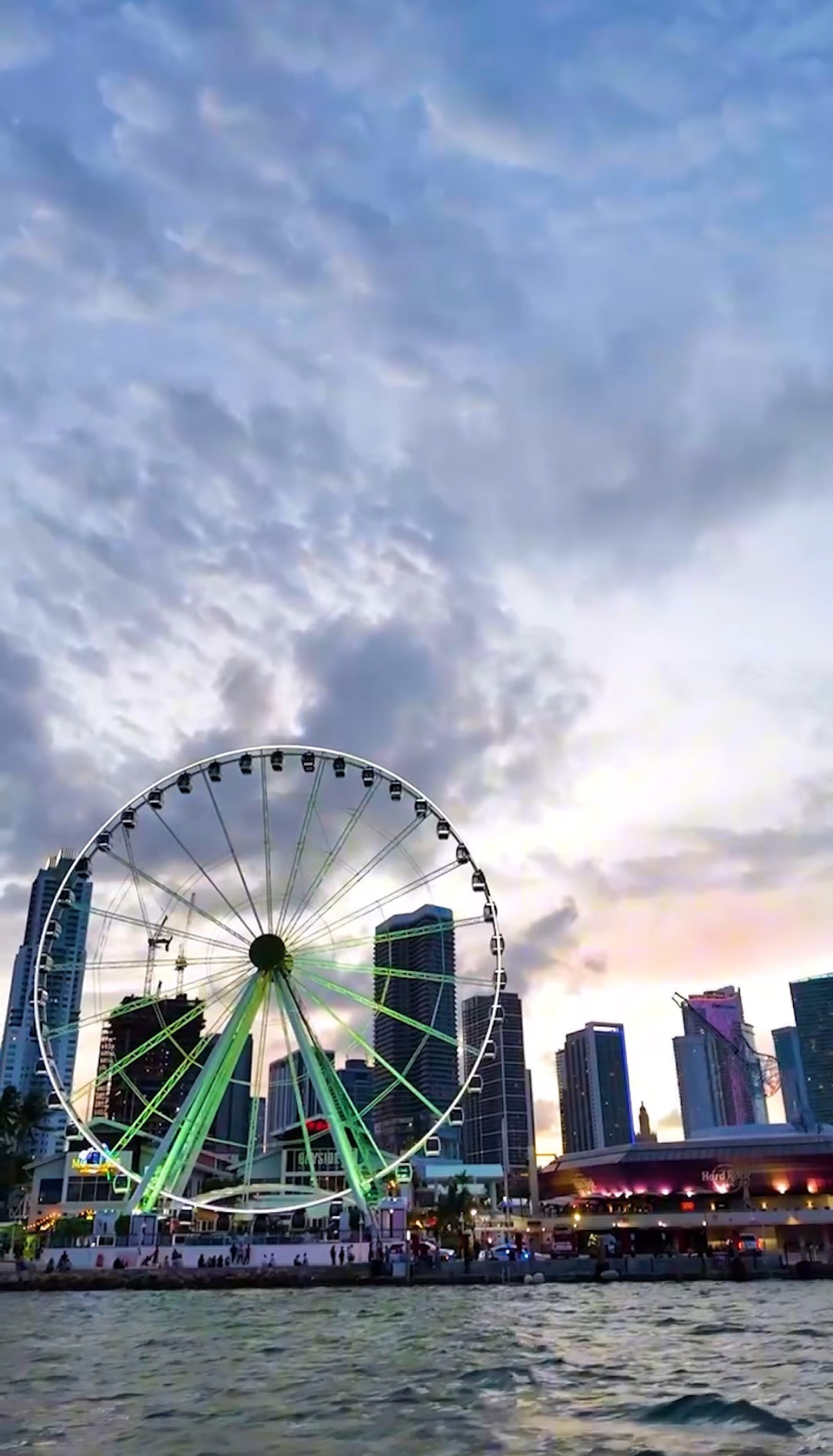 brown and white concrete building near green trees and body of water during daytime