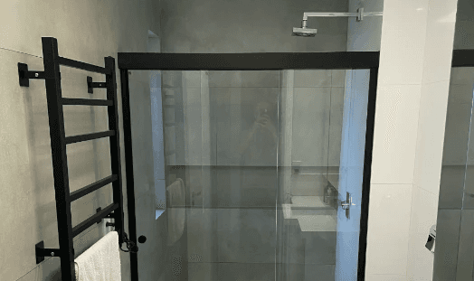 man wearing gray polo shirt beside dry-erase board