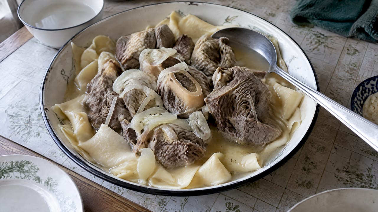 Beshbarmak served with lamb broth and flat dough