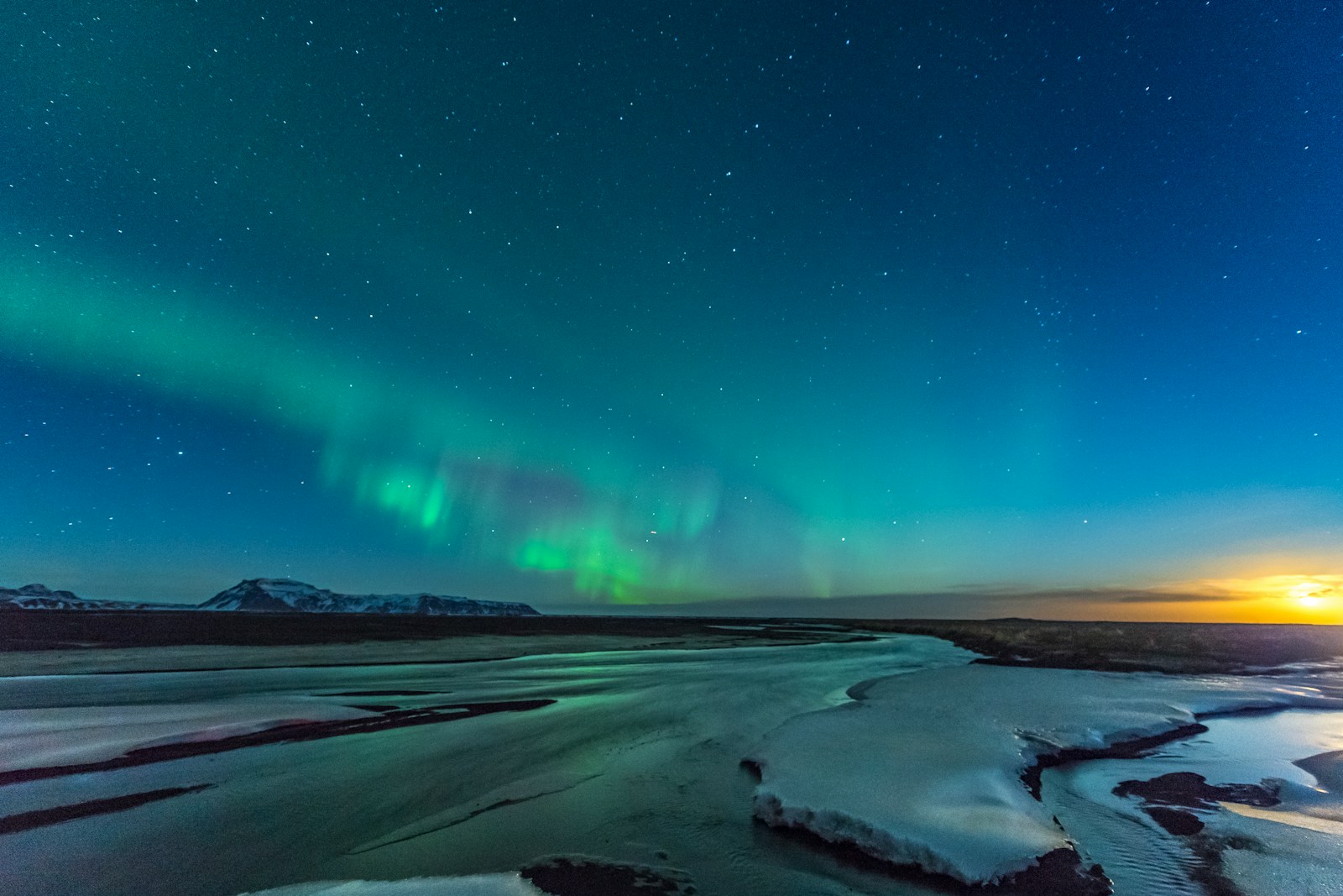 Northern lights aurora borealis dancing over Iceland snowscape