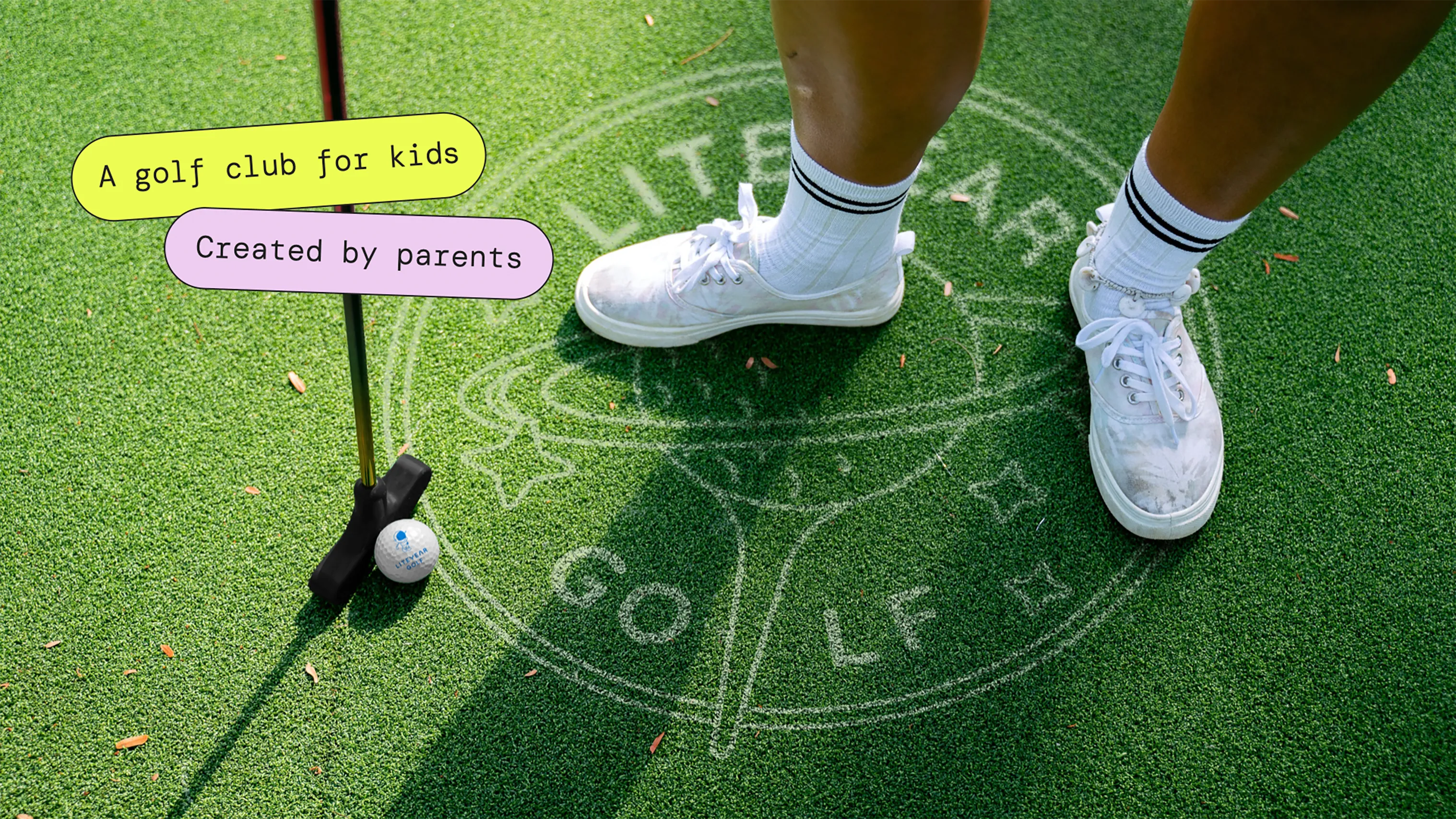 Child standing beside a golf ball and club on grass with Liteyear Golf branding