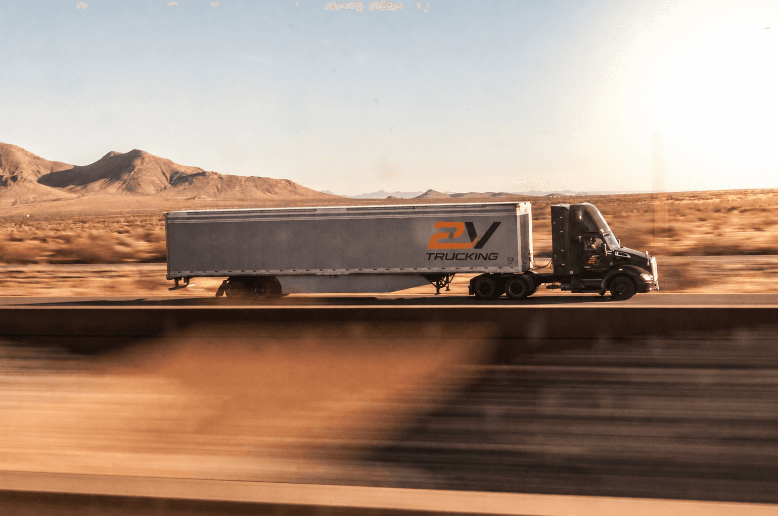 a truck driving down the road in the desert
