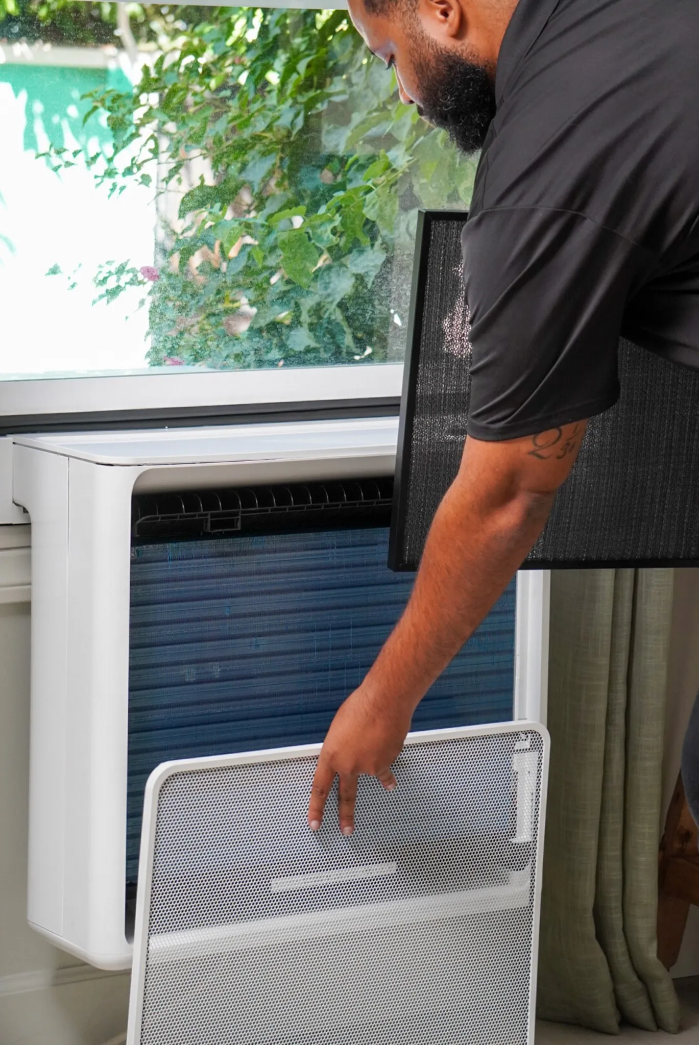 Installer securing a Gradient heat pump in a window