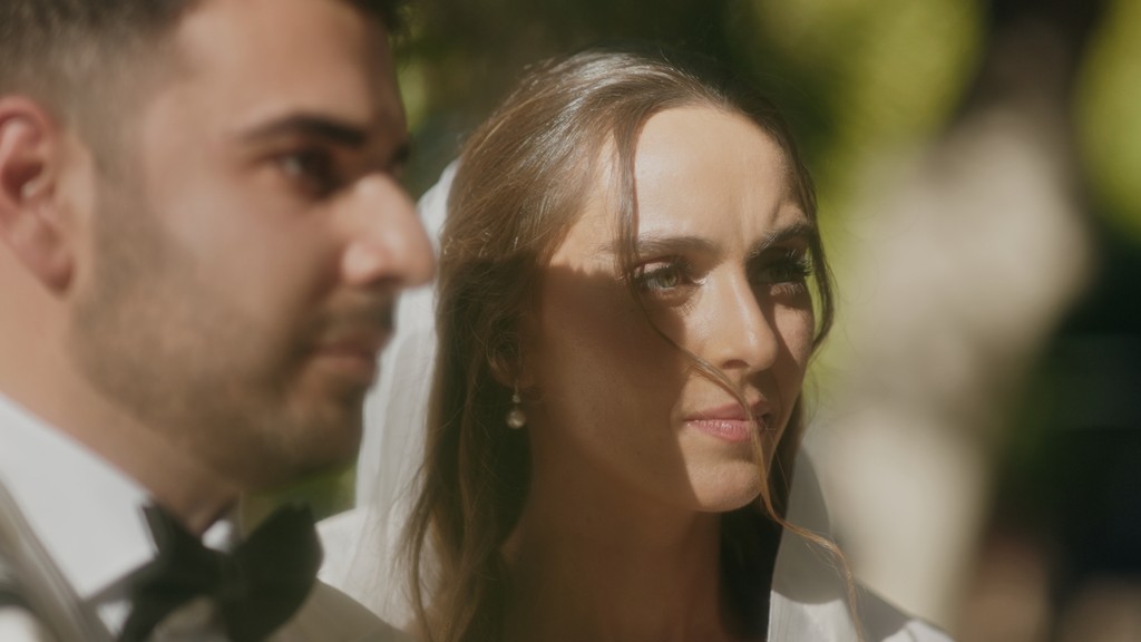 The bride is putting on her earrings.