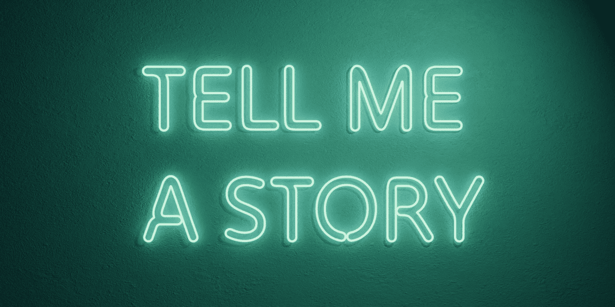 Neon sign saying TELL ME A STORY