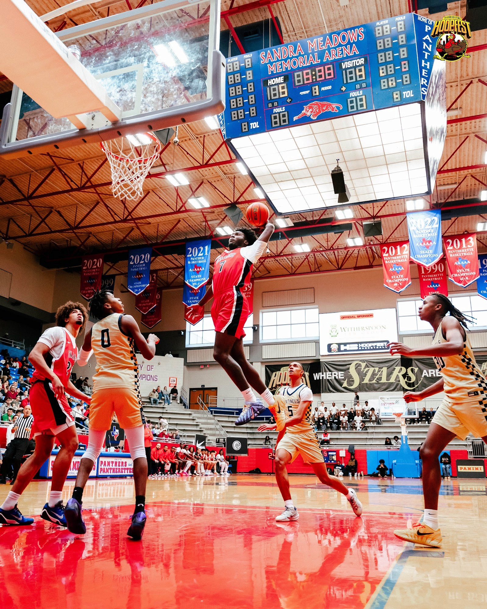 Three people sitting on a couch in a room looking at mobile devices