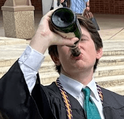 woman staring directly at camera near pink wall