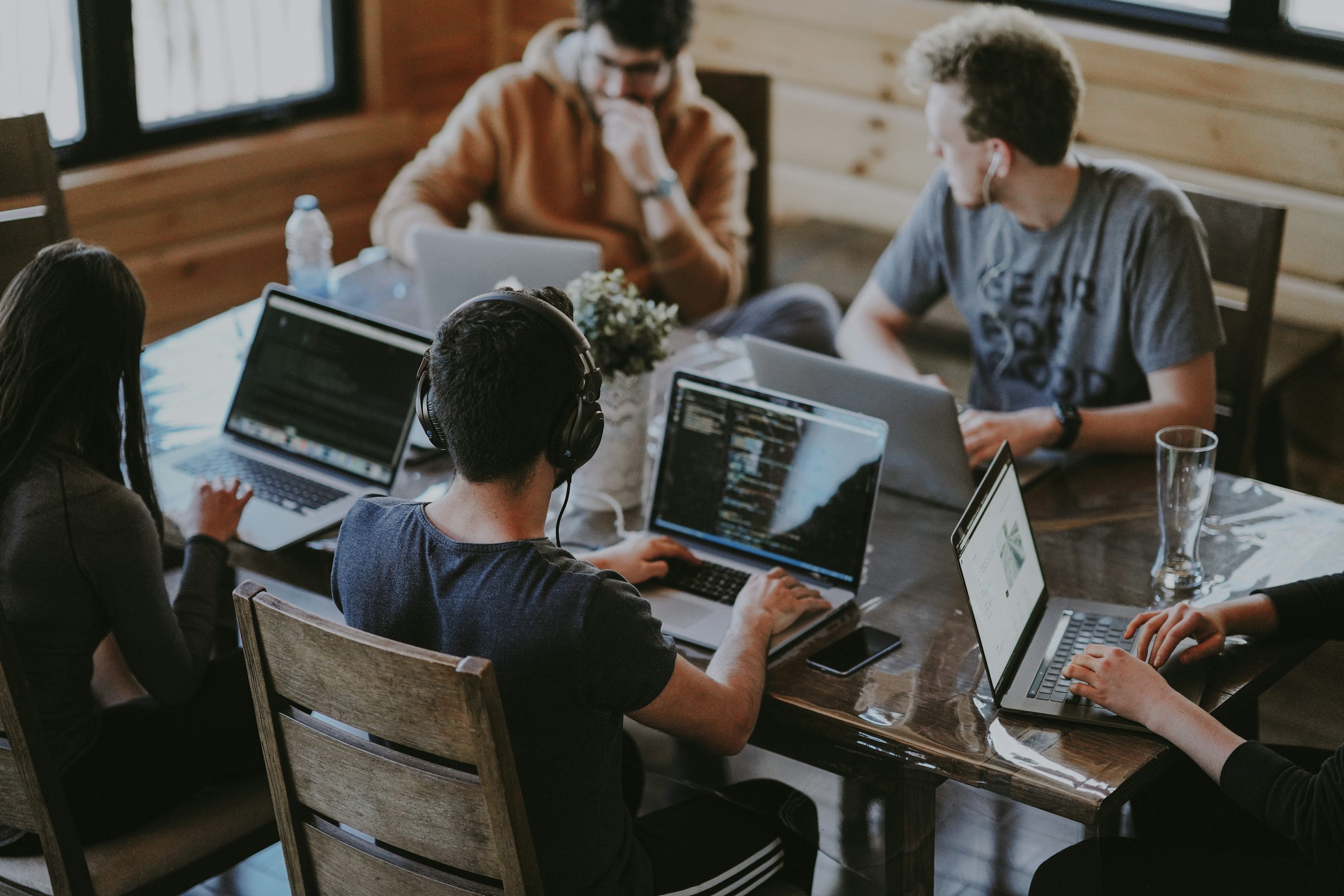 people sitting on chair in front of laptop computers