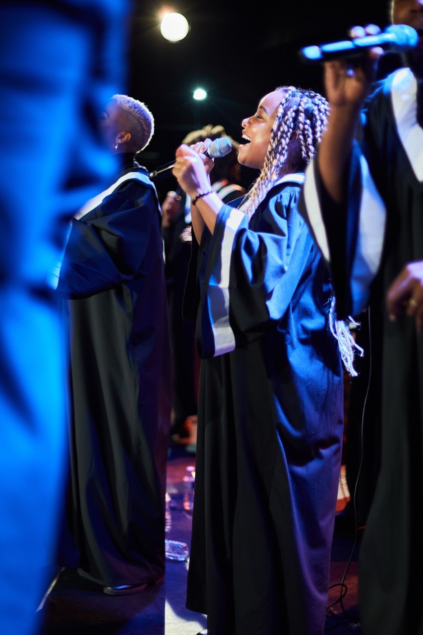 man in blue suit kissing woman in white wedding dress