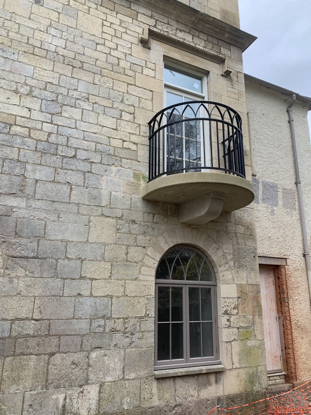 Hand carve stone juliette balcony on a cotswold stone property