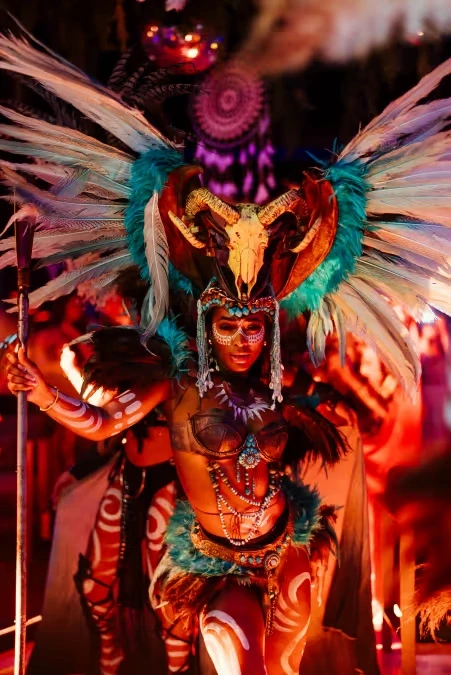 Performer in a feathered headdress with a ram skull and white body paint at The Penthouse Dubai