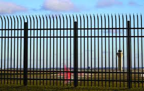 Industrial Defender security fence with angled spears protecting a commercial airport.