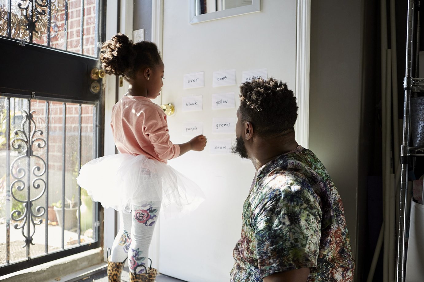 A father and daughter play together.