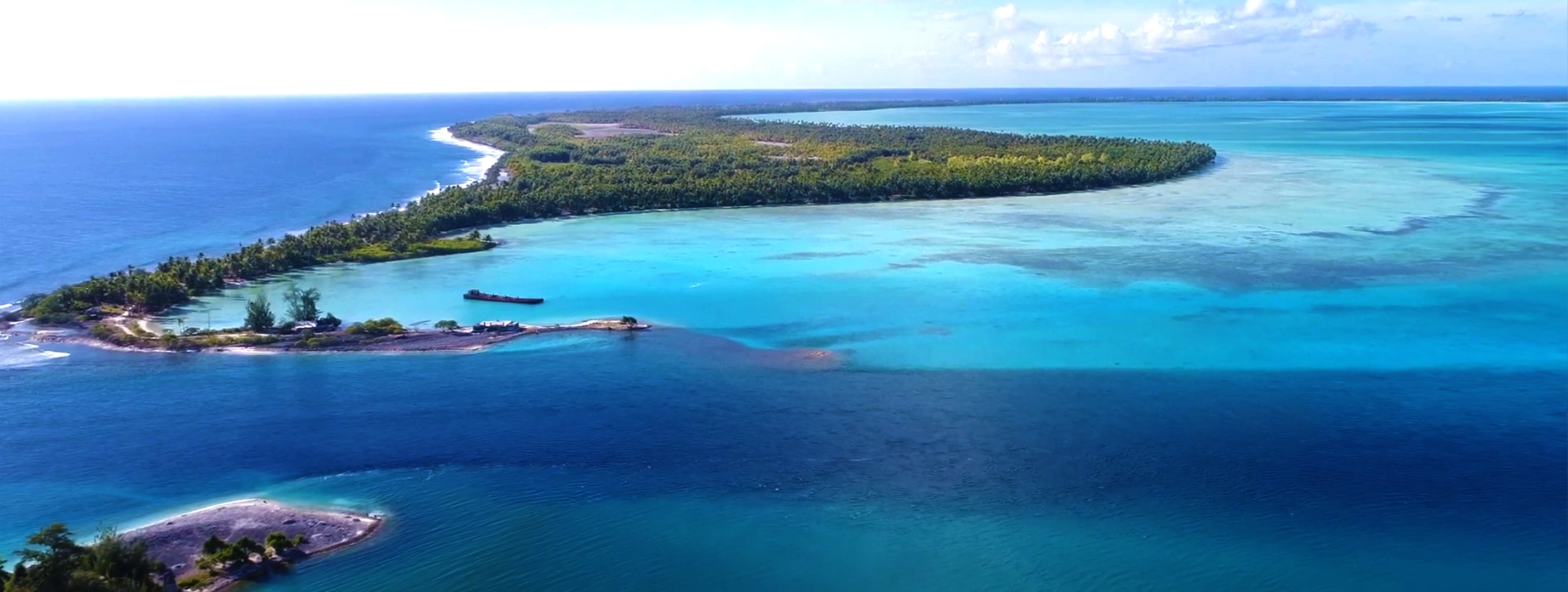 woman holding a phone and man looking at the phone. both are smiling