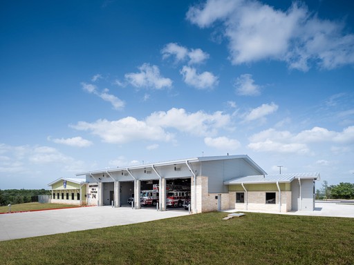 A person stands in a sandstone cave.