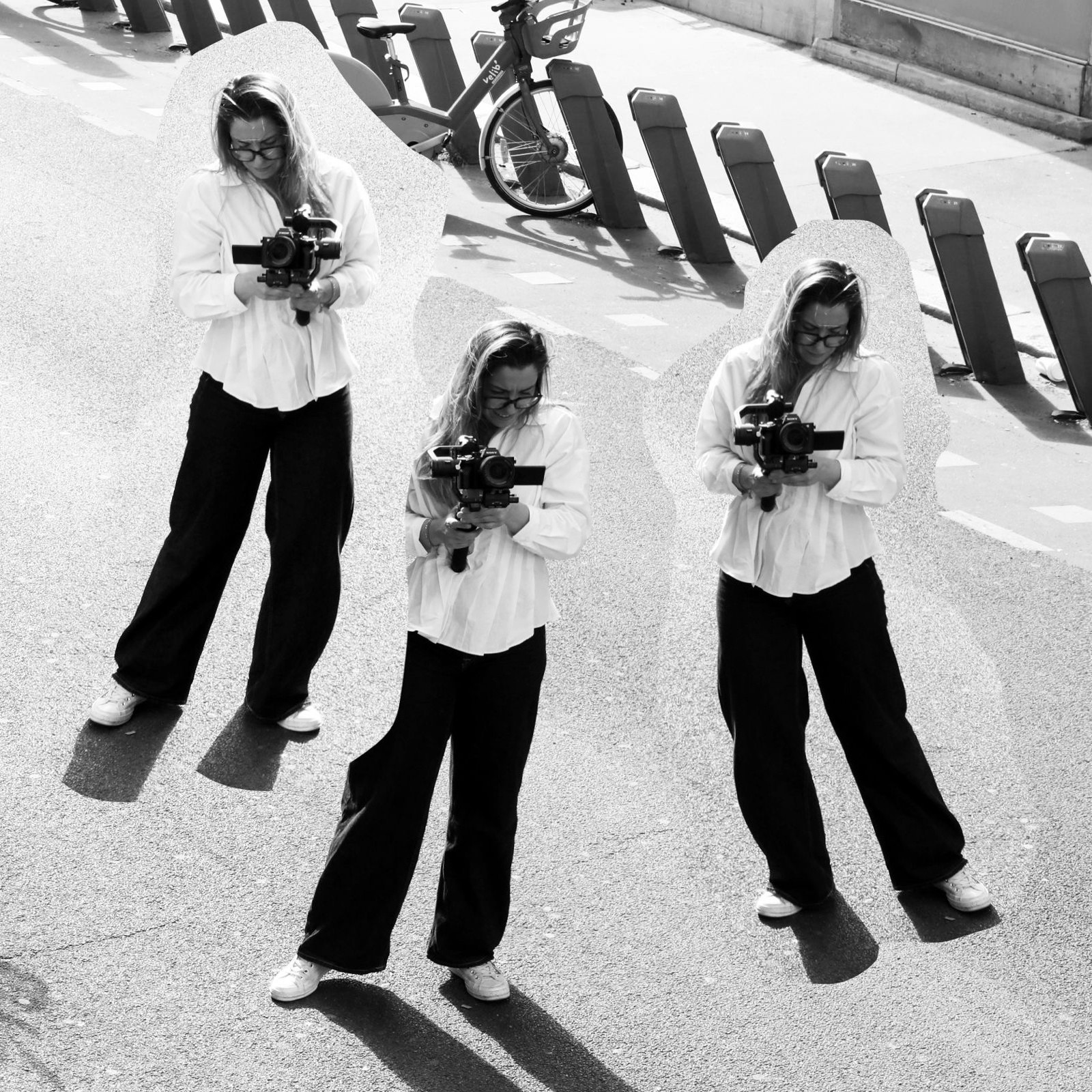 A hand wrapped in crinkled, translucent plastic reaches upwards against a dark background. The light highlights textures, evoking themes of entrapment and fragility.