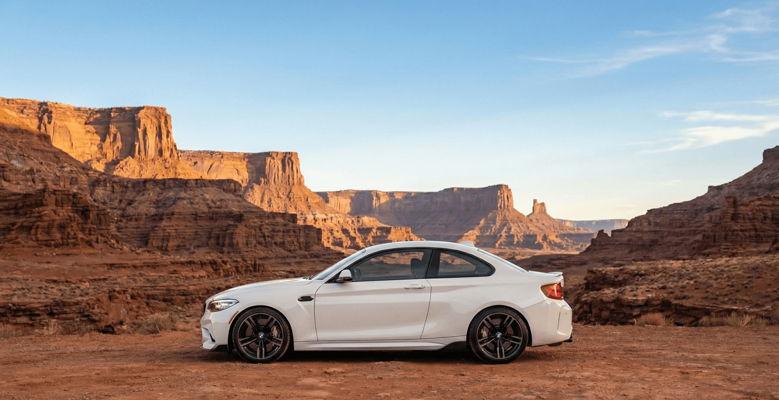 white BMW F87 M2 Competition, a high-performance sports coupe known for its potent twin-turbo 6-cylinder engine and compact design. 
