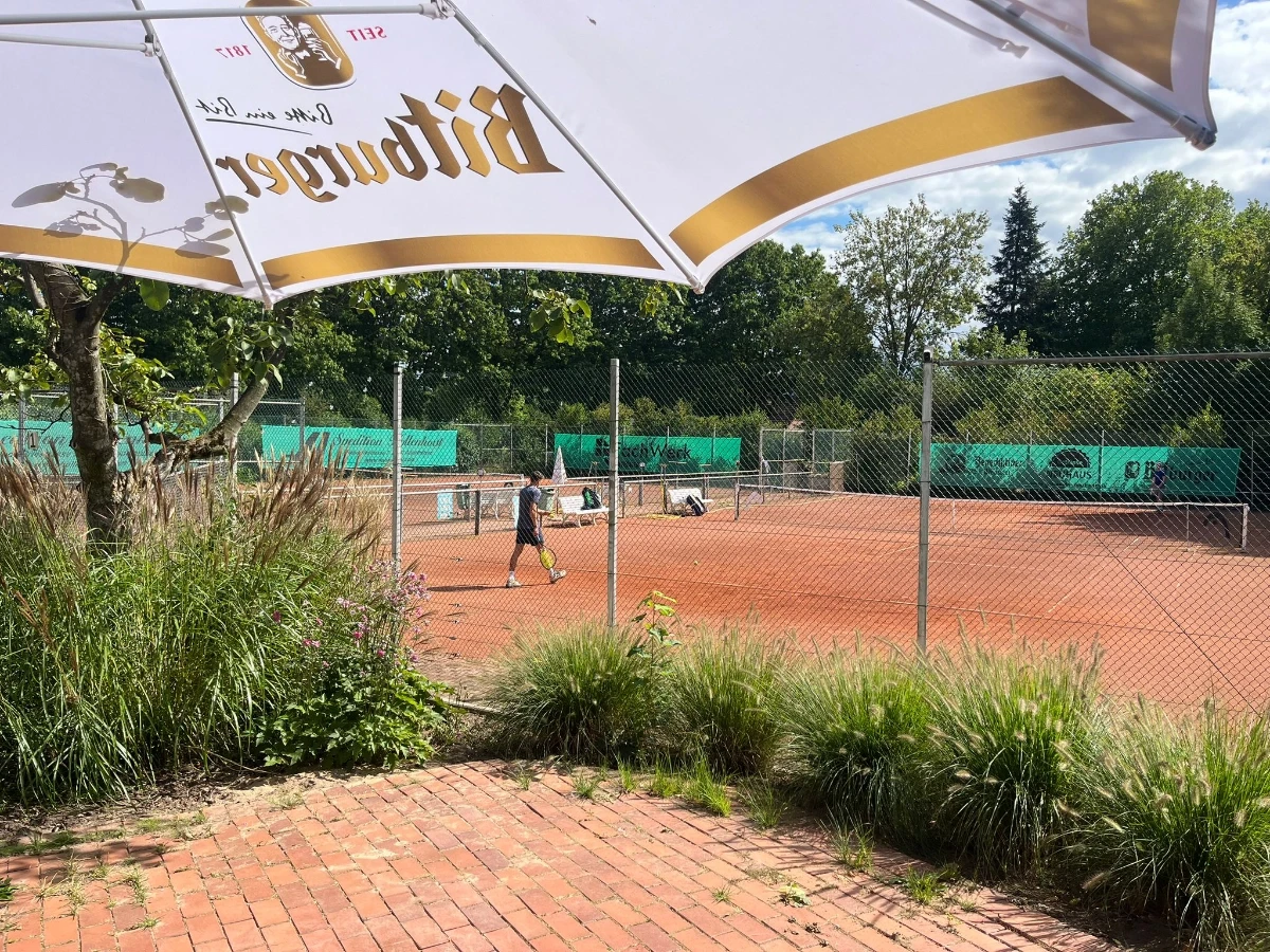 a man holding a tennis racquet on a tennis court
