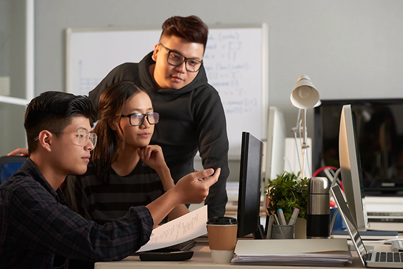 A collaborative offshore tech team working in a modern office environment.