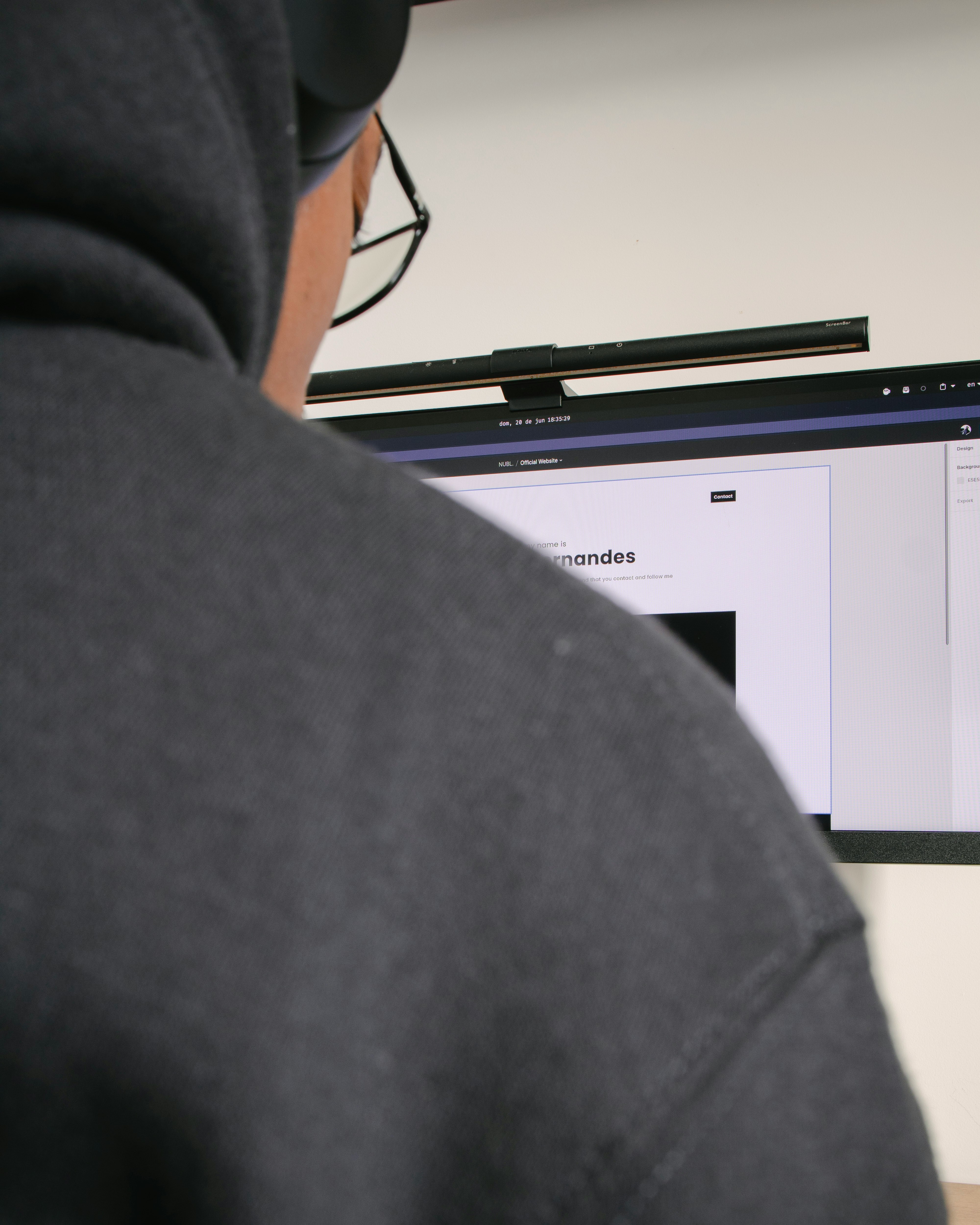 person in black shirt near white and black wooden cabinet