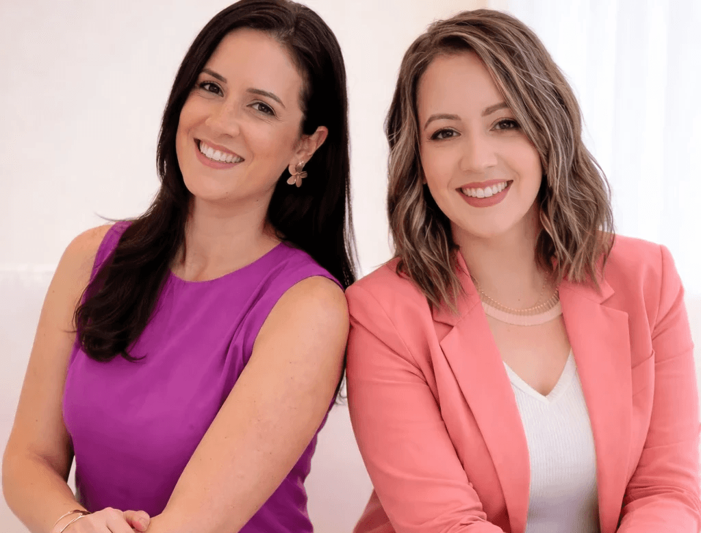 woman sitting while working on laptop and smiling 