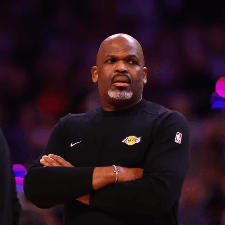 Nate McMillan in a Lakers quarter zip with his arms folded. 