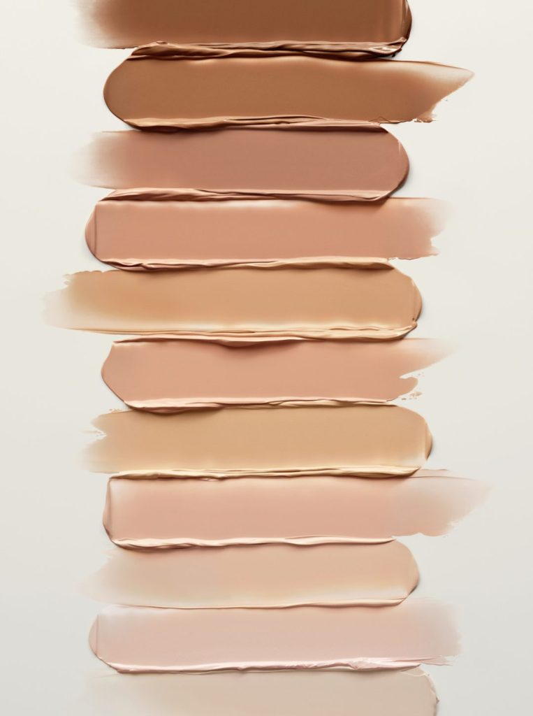 Nine swatches of various skin tone shades arranged vertically on a light background.