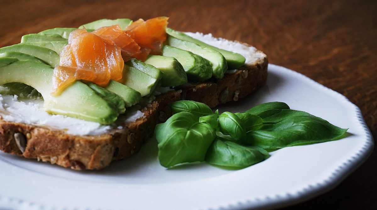A plate features avocado toast with lox.