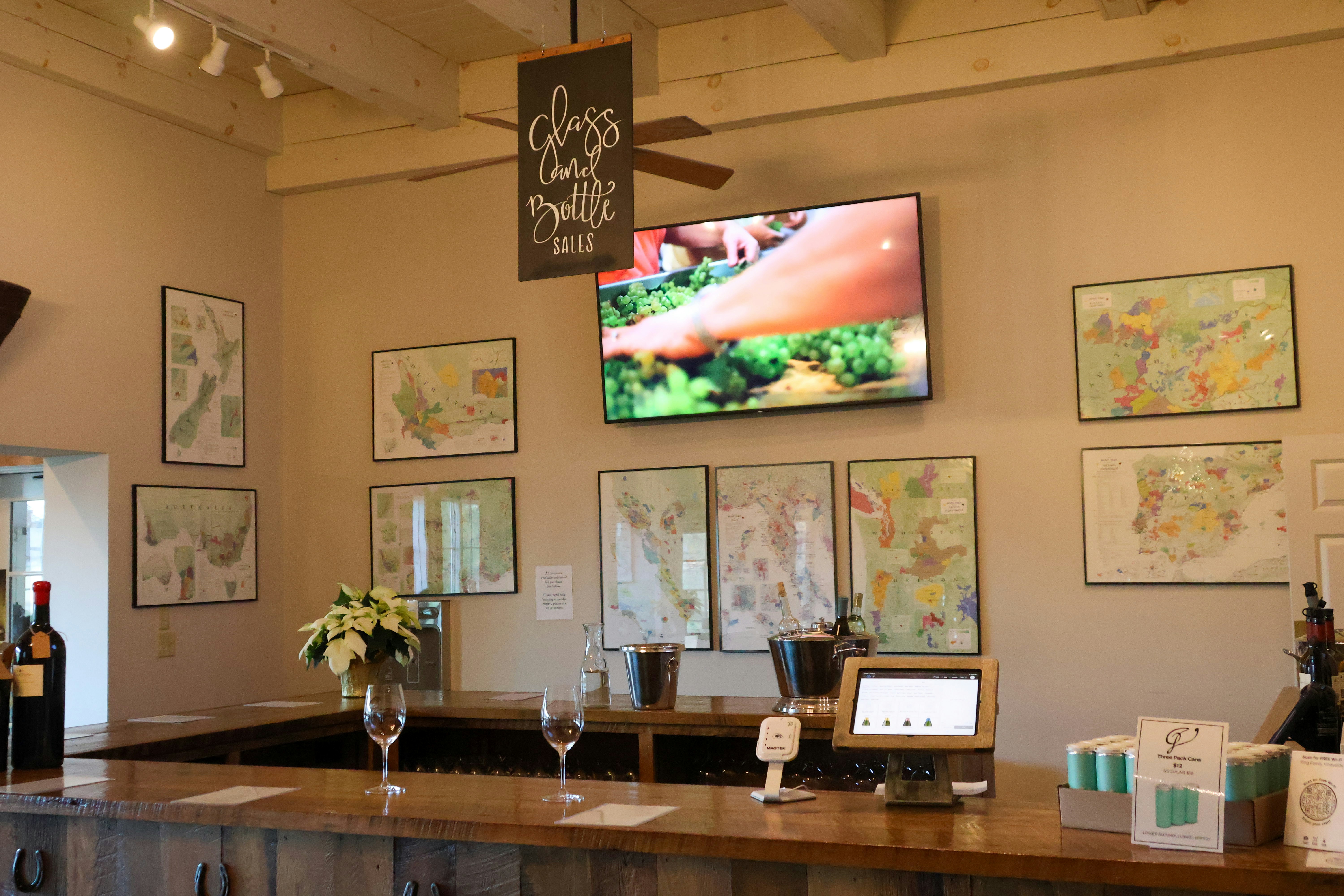 A bar with wine glasses and bottles on it