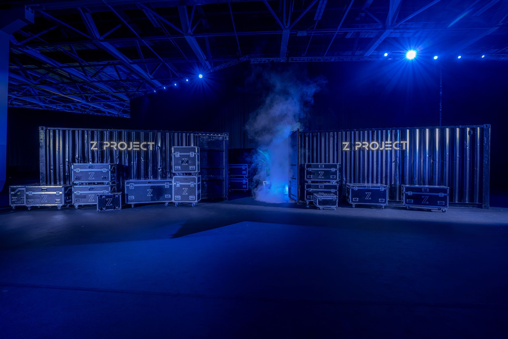 Orange armchair beside potted palm against yellow wall.