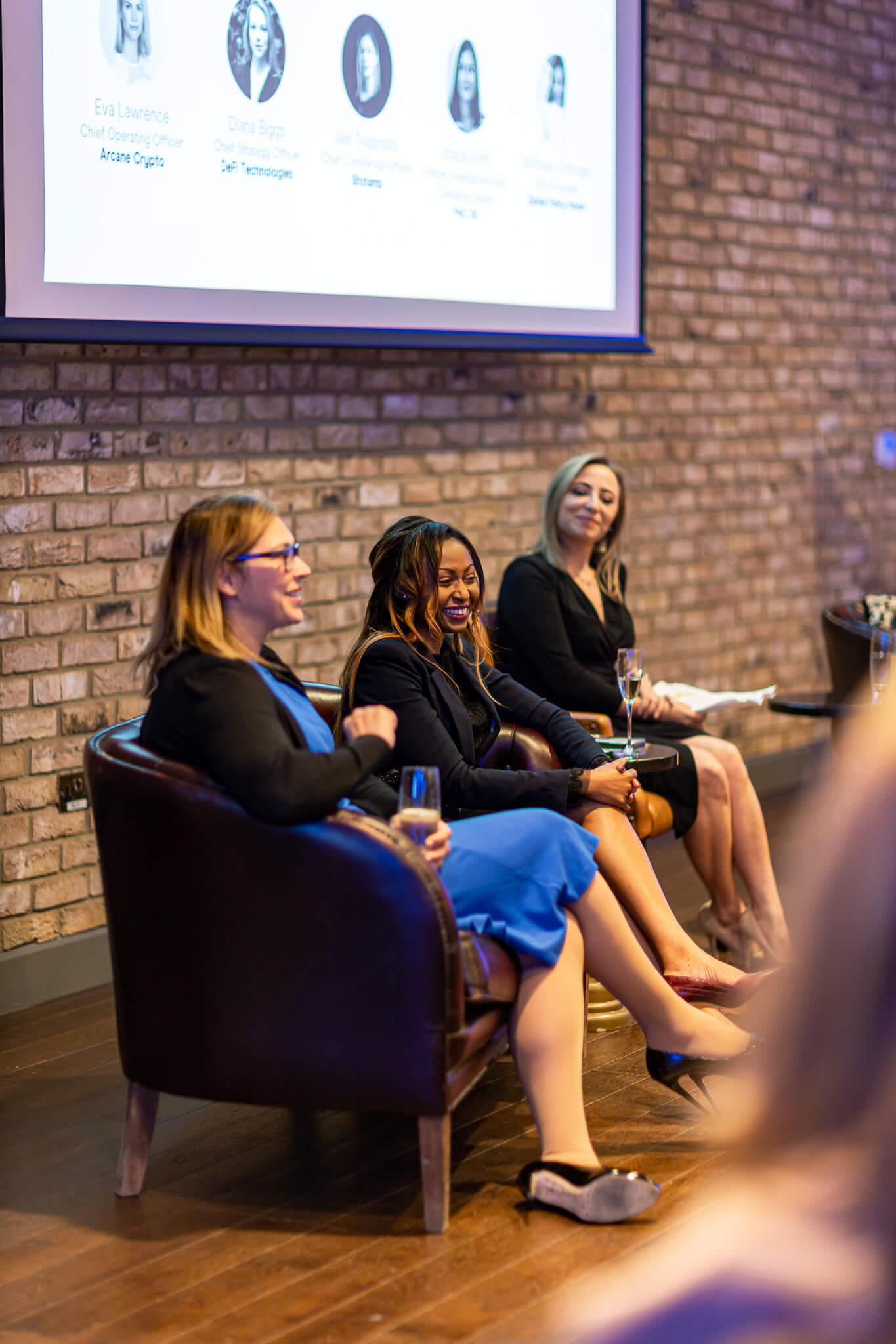 Women speaking during a live finance panel discussion at a professional networking event