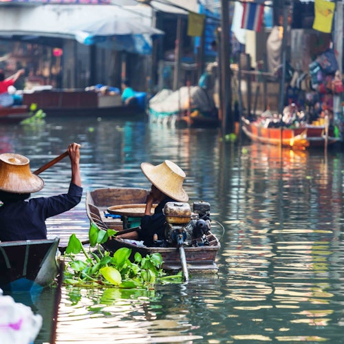 Local farmer riding in the khlongs heading to the Floating Market