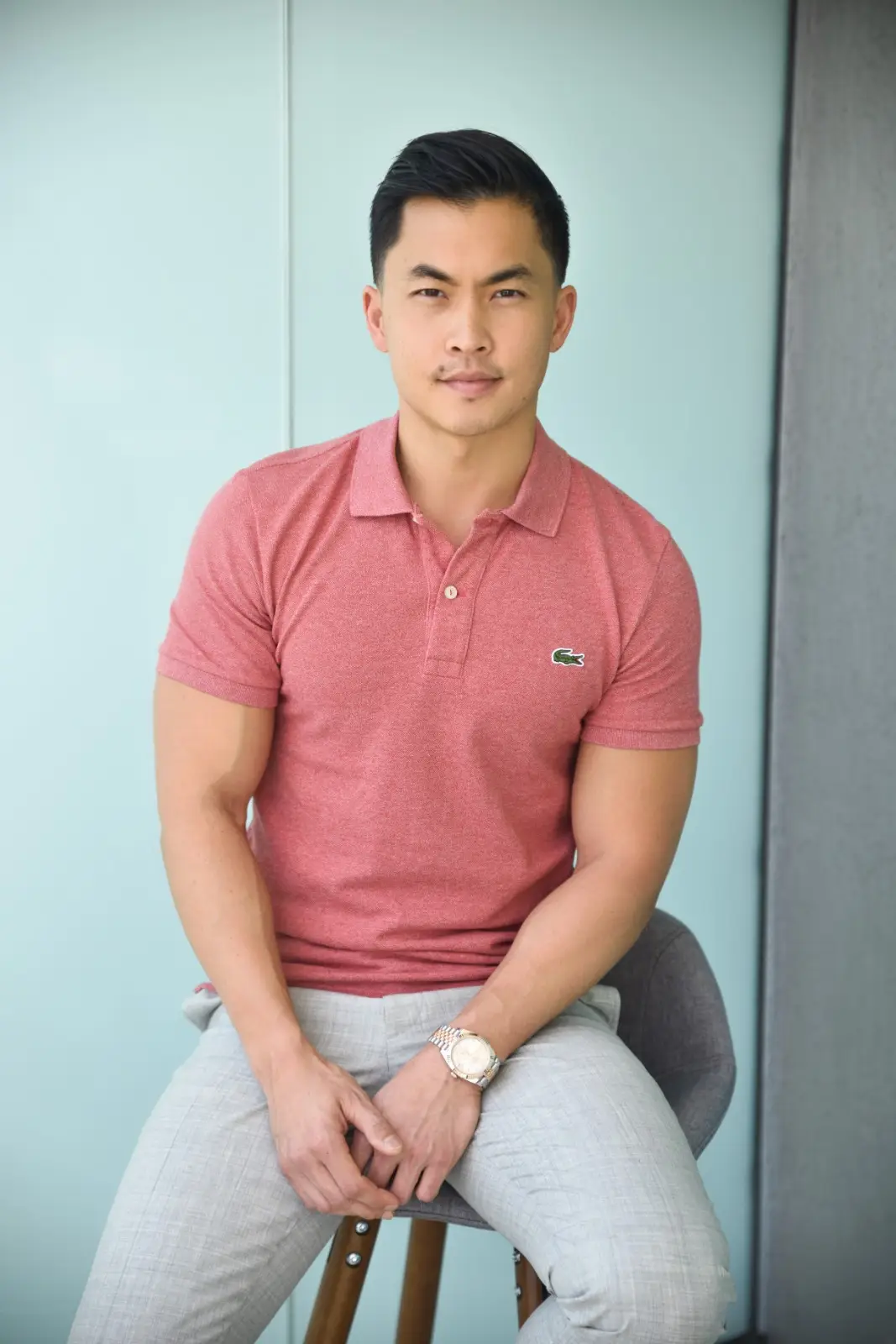 A girl holding a sunflower in a sunflower field on a bright day