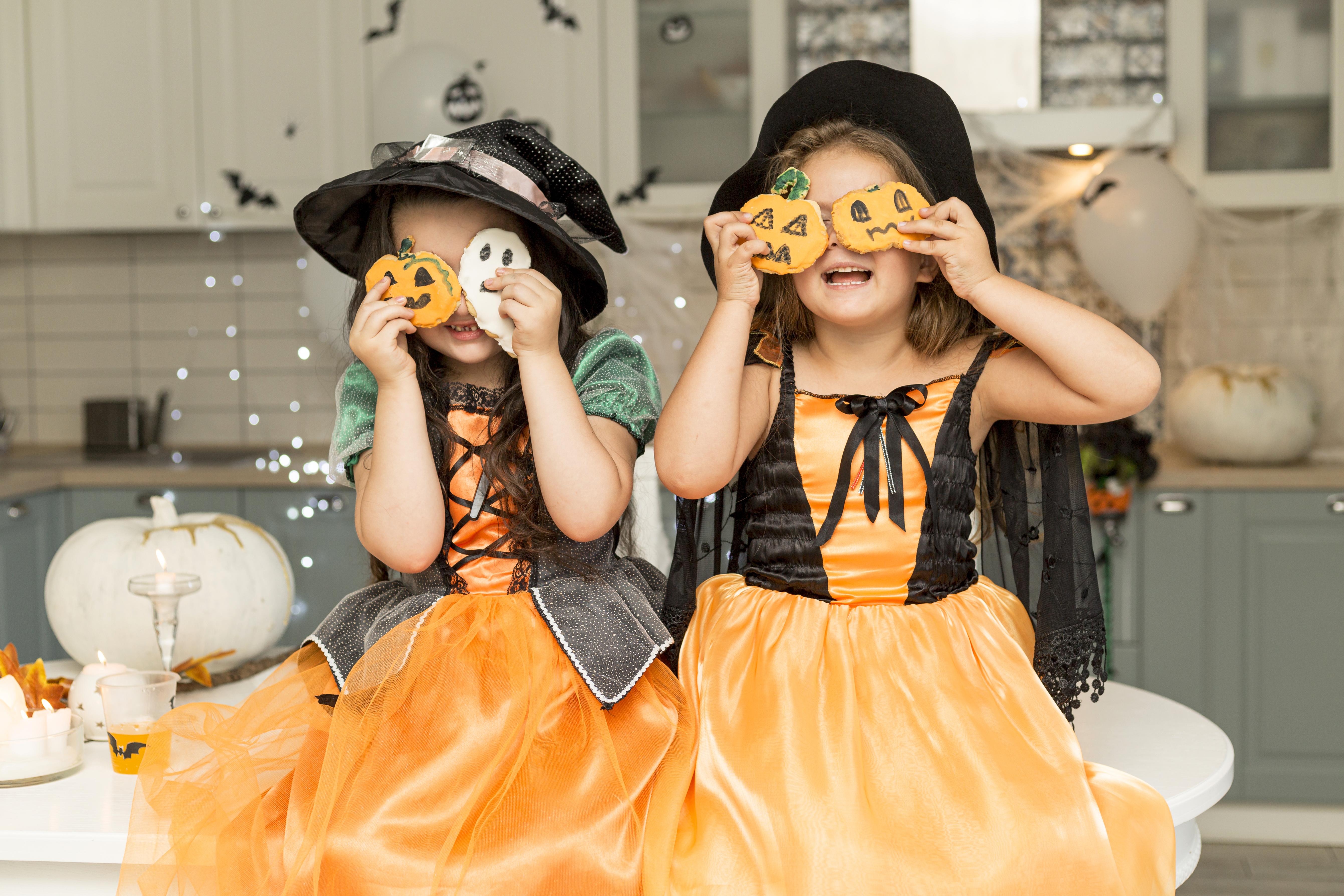 Front view of cute girls with witch costume