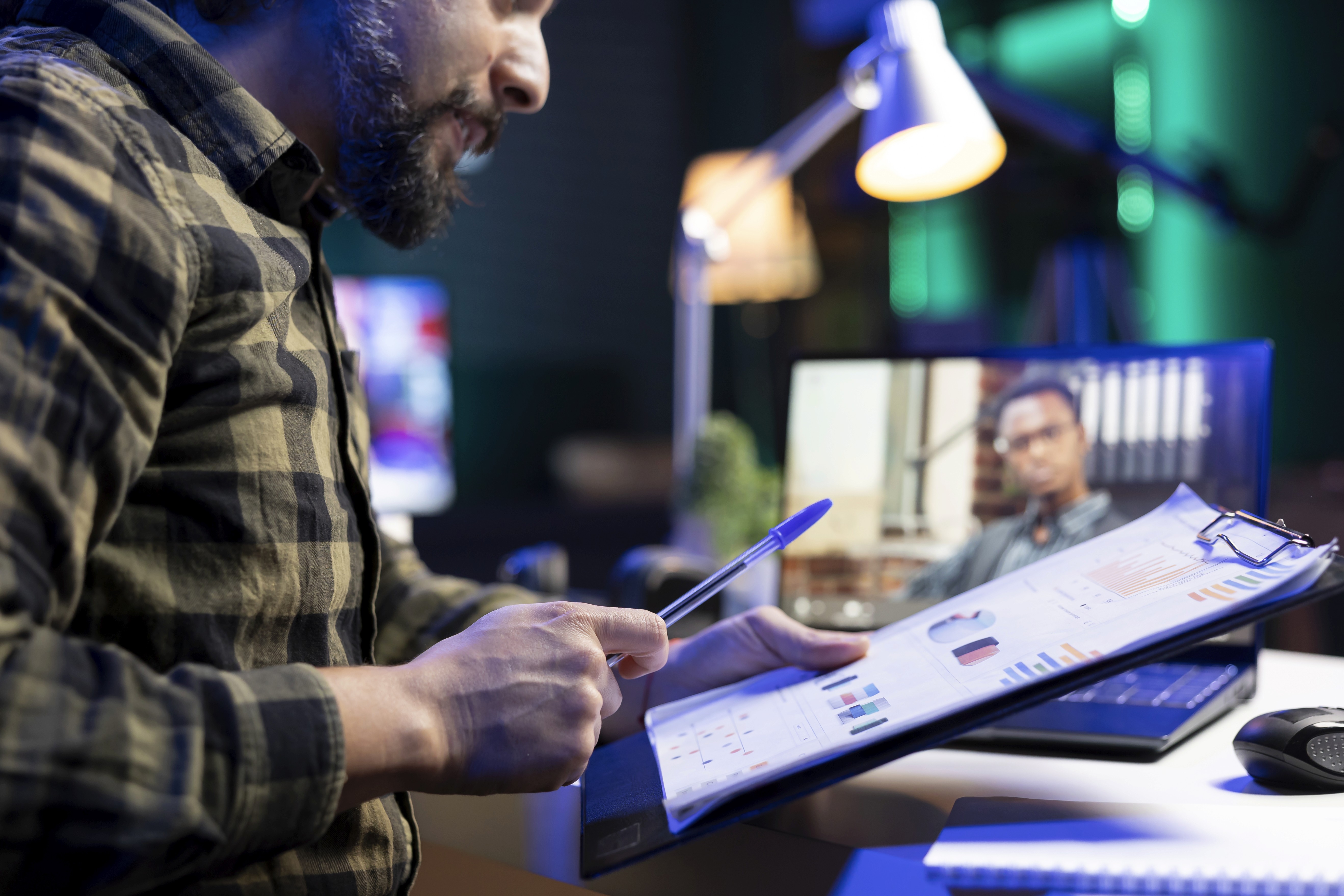 The image features a young woman and man sitting at a table, presumably engaged in a serious discussion or a collaborative task.