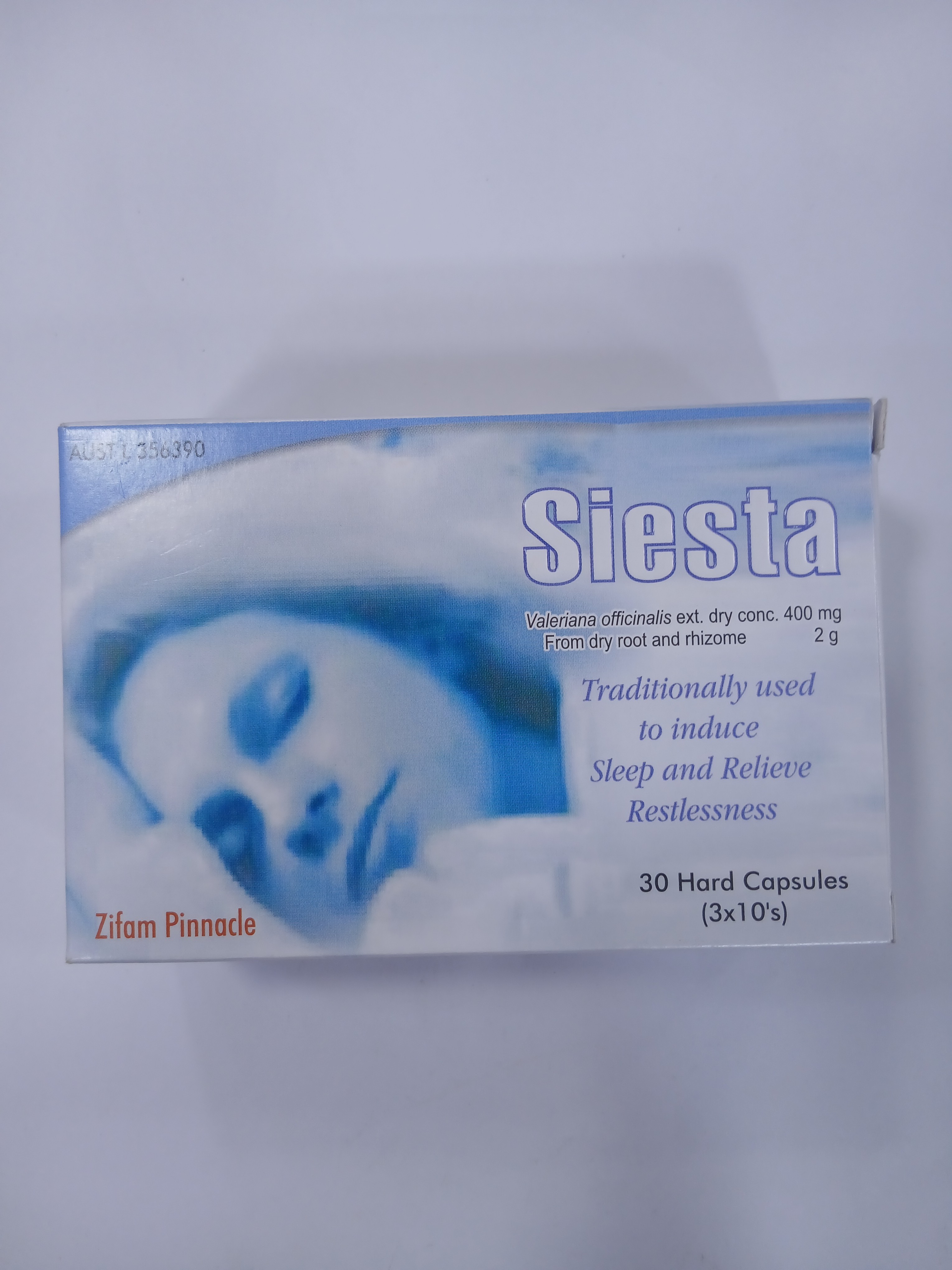 White cardboard packaging displays a blue-toned image of a sleeping person with closed eyes, featuring text indicating it contains 30 hard capsules in three blister packs of ten.