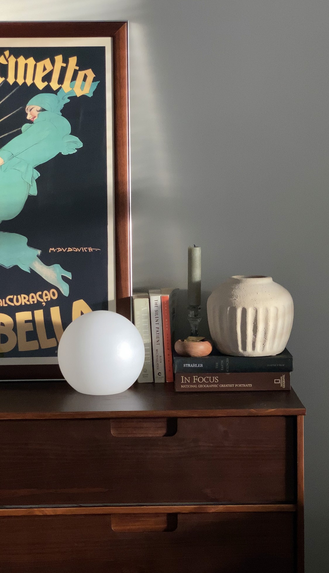 desk with books, portrait and decoration at a brand and content agency office