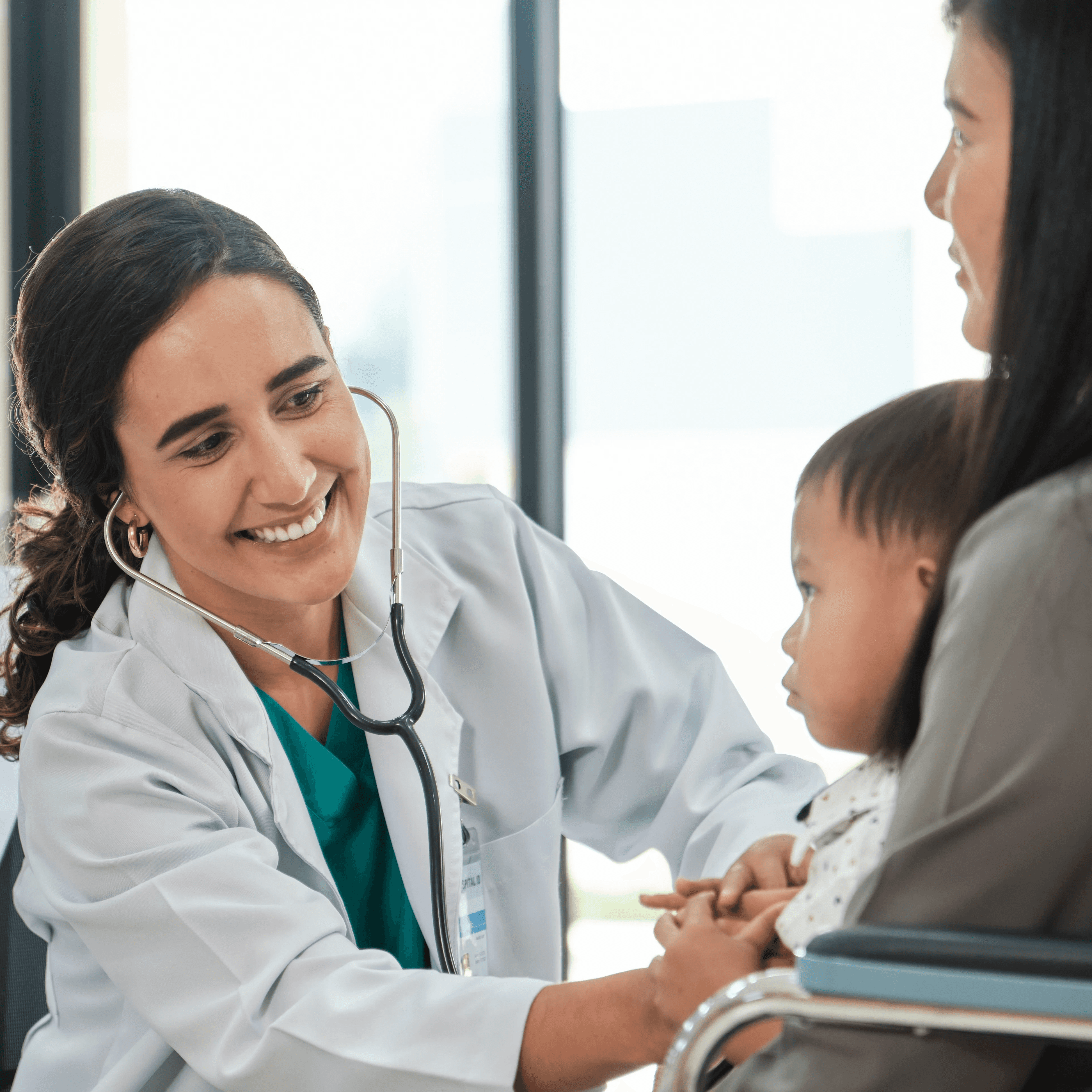 doctor checking heart of child with mother using stethoscope