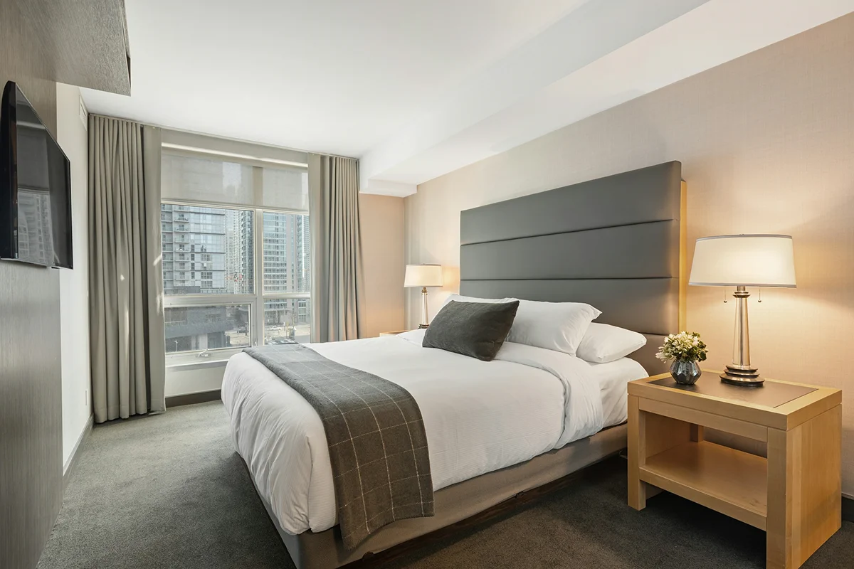 Double room with a double bed, bedside lighting, and city view.