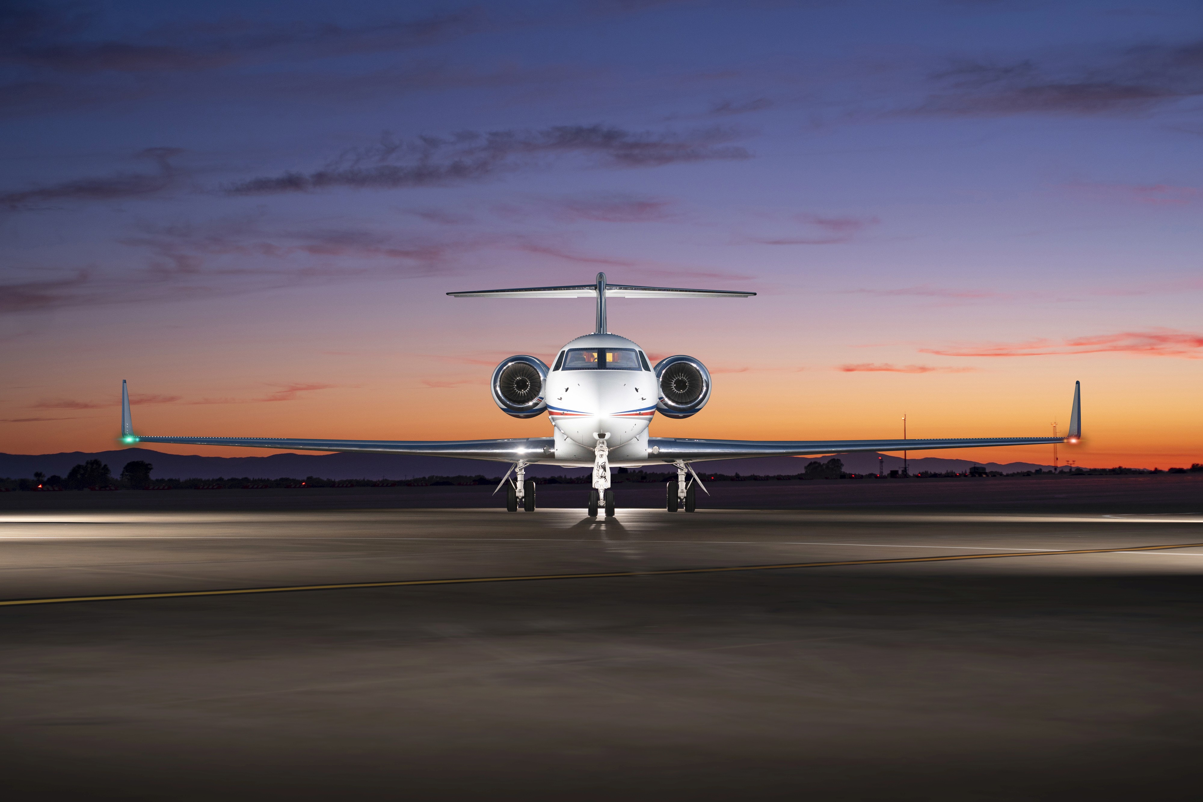 private jet on runway facing camera