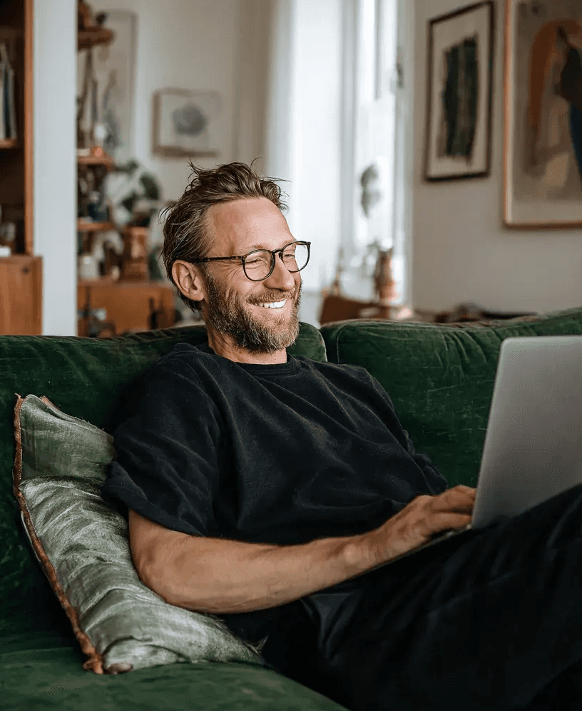 A man smiling and relaxed because he has a subscription to design agency in shreveport, DesignPing