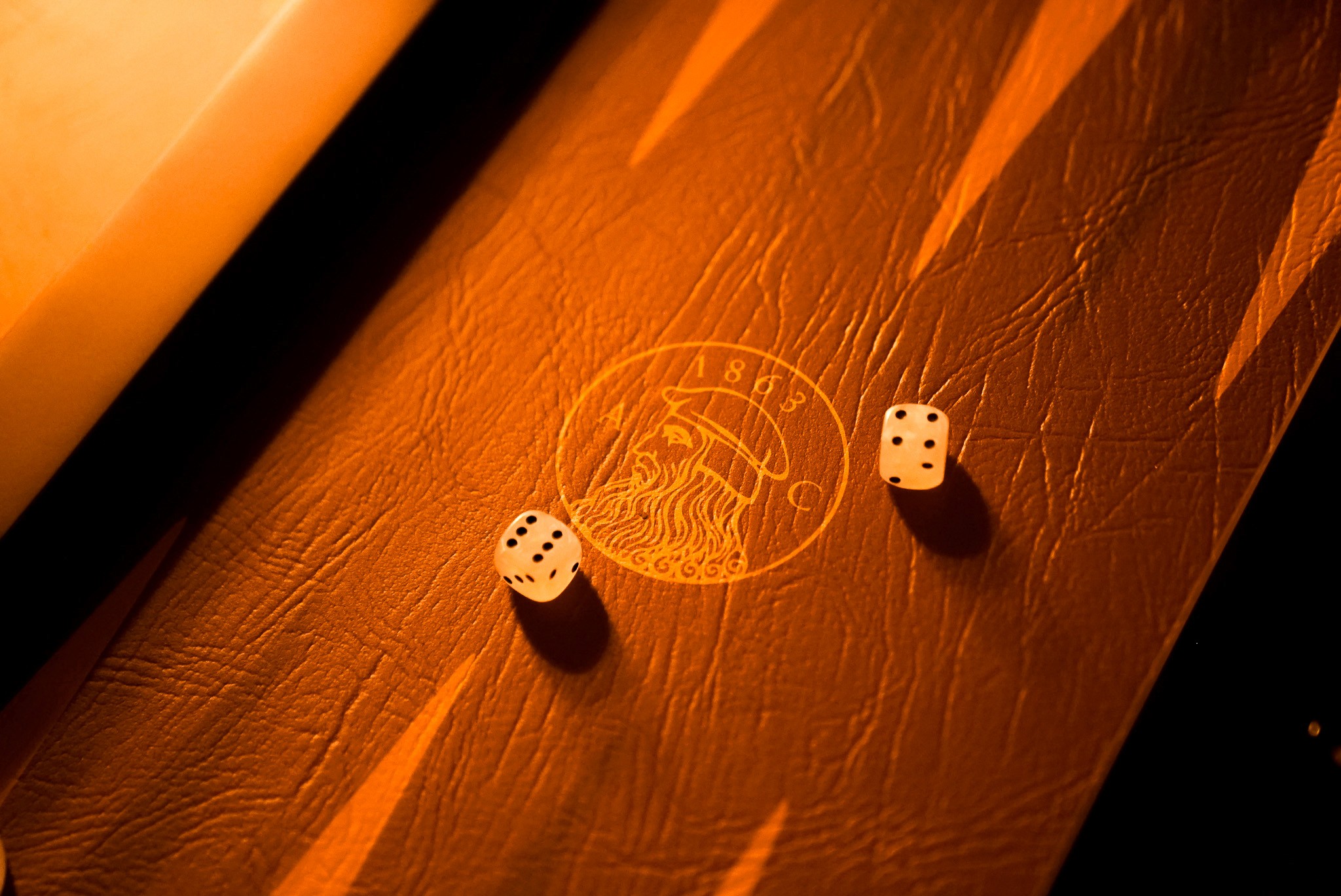 Bride sitting on ground against wall, groom standing nearby