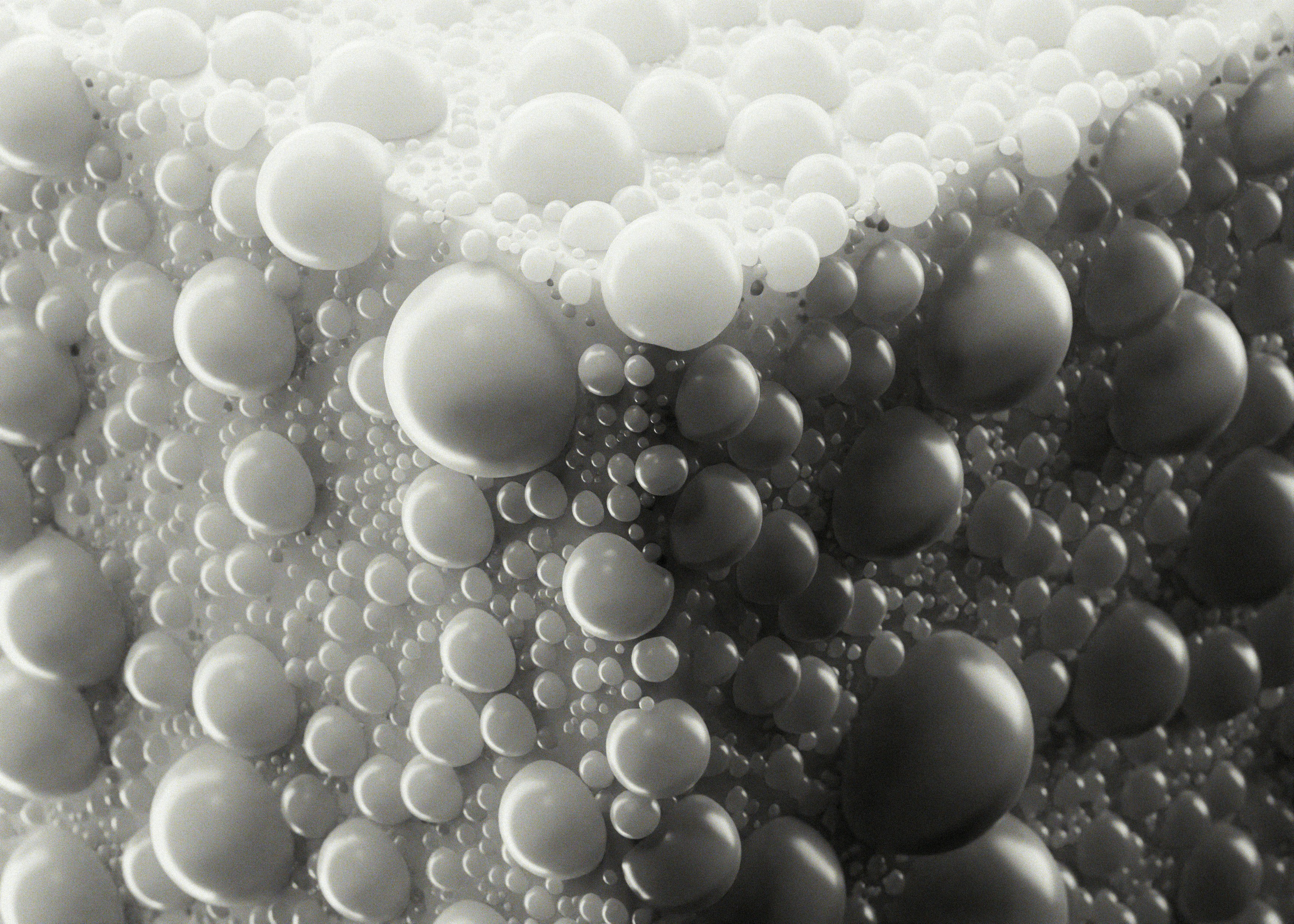 Abstract pattern of many small and large spheres.
