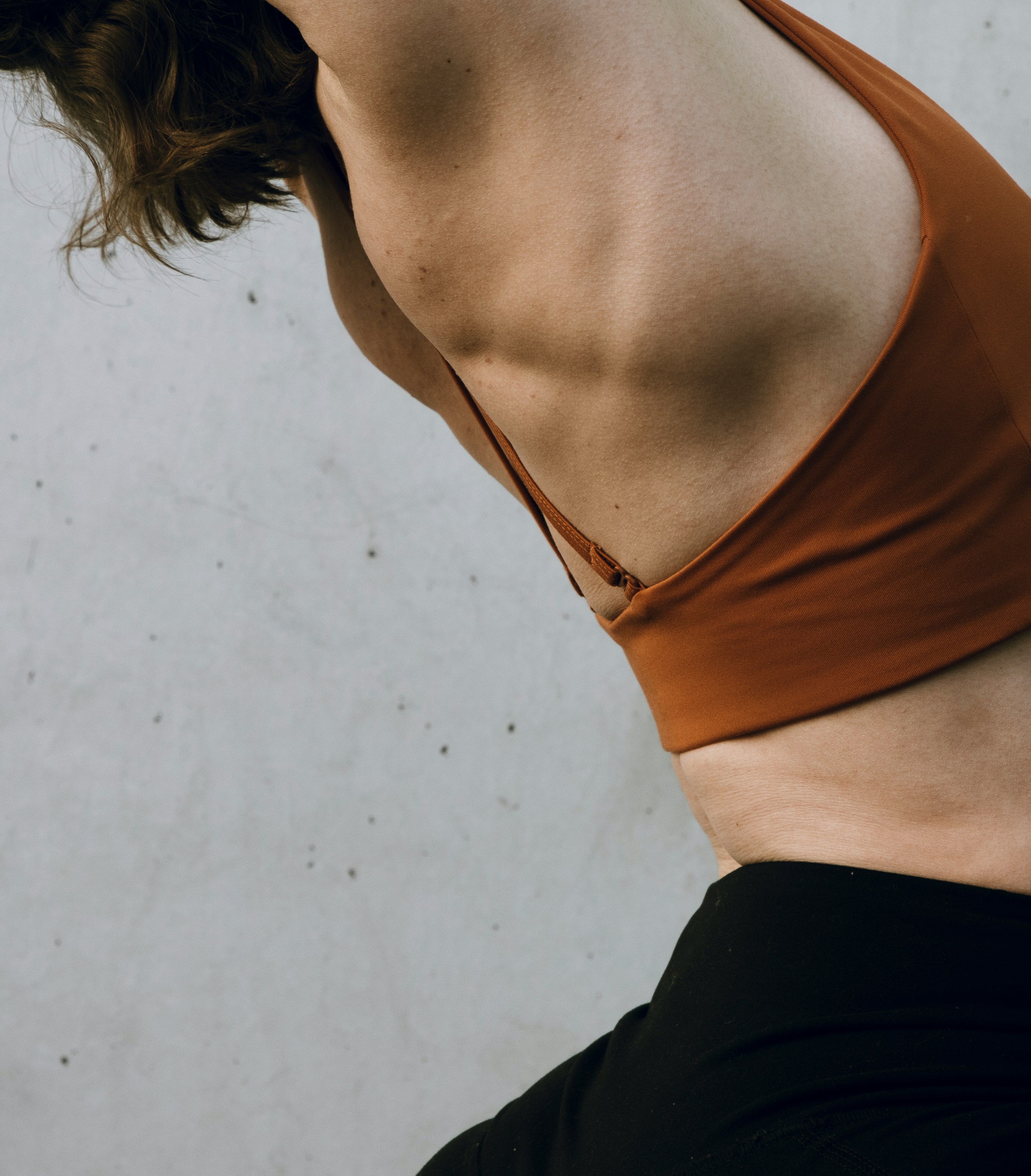 a woman in a brown top and black pants
