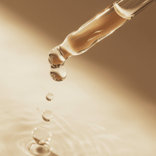 A serum dispenser with liquid drops coming out