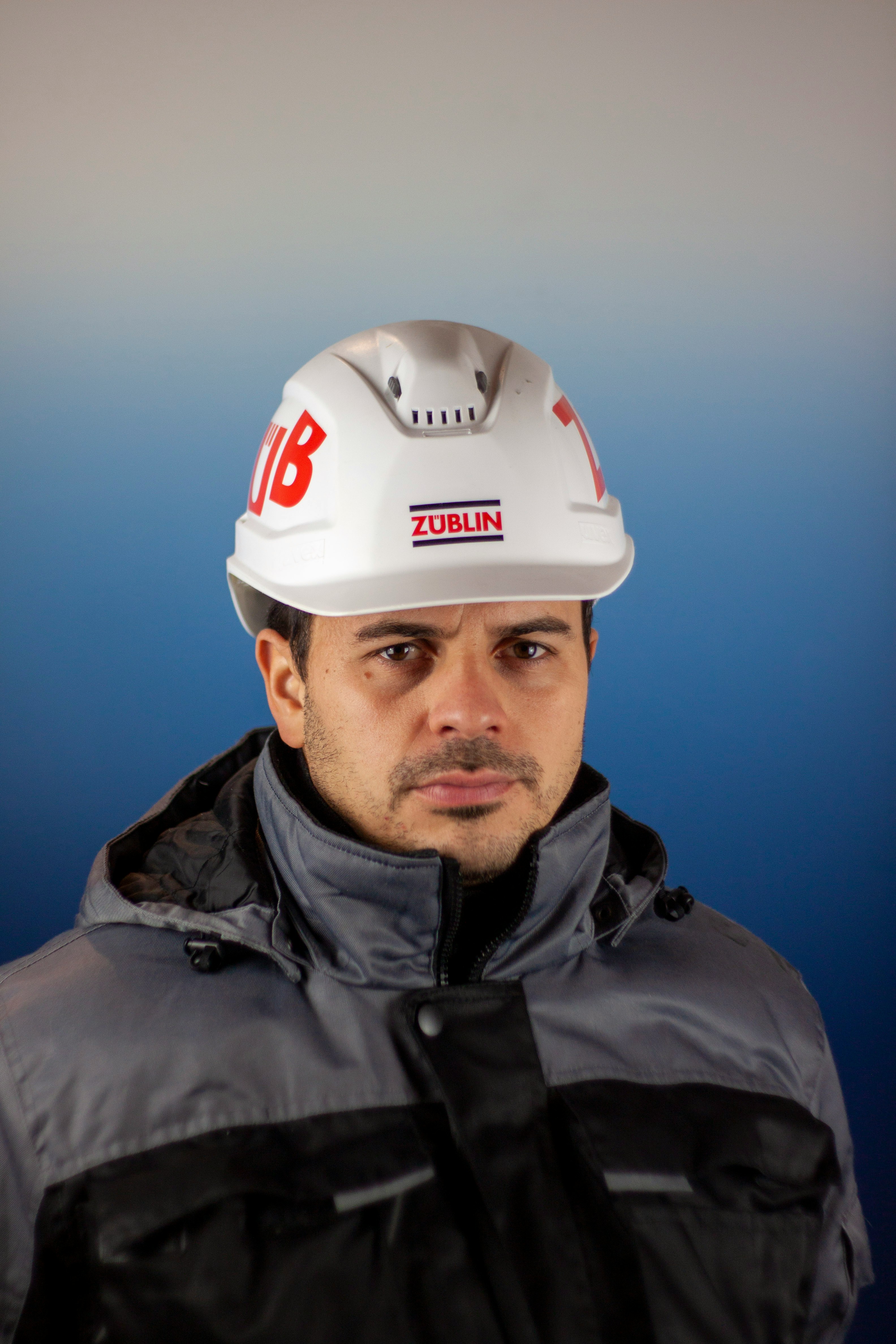 a man wearing a hard hat and jacket