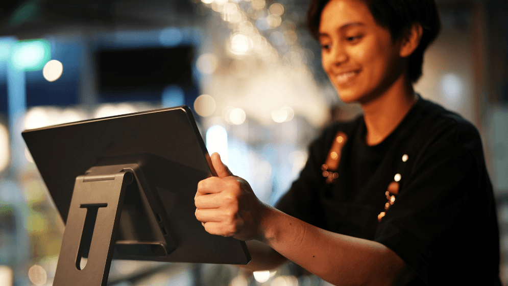 A Malaysian F&B staff with a POS system