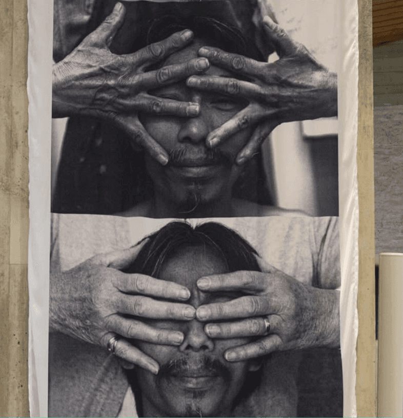 a group of women standing on top of a sandy beach