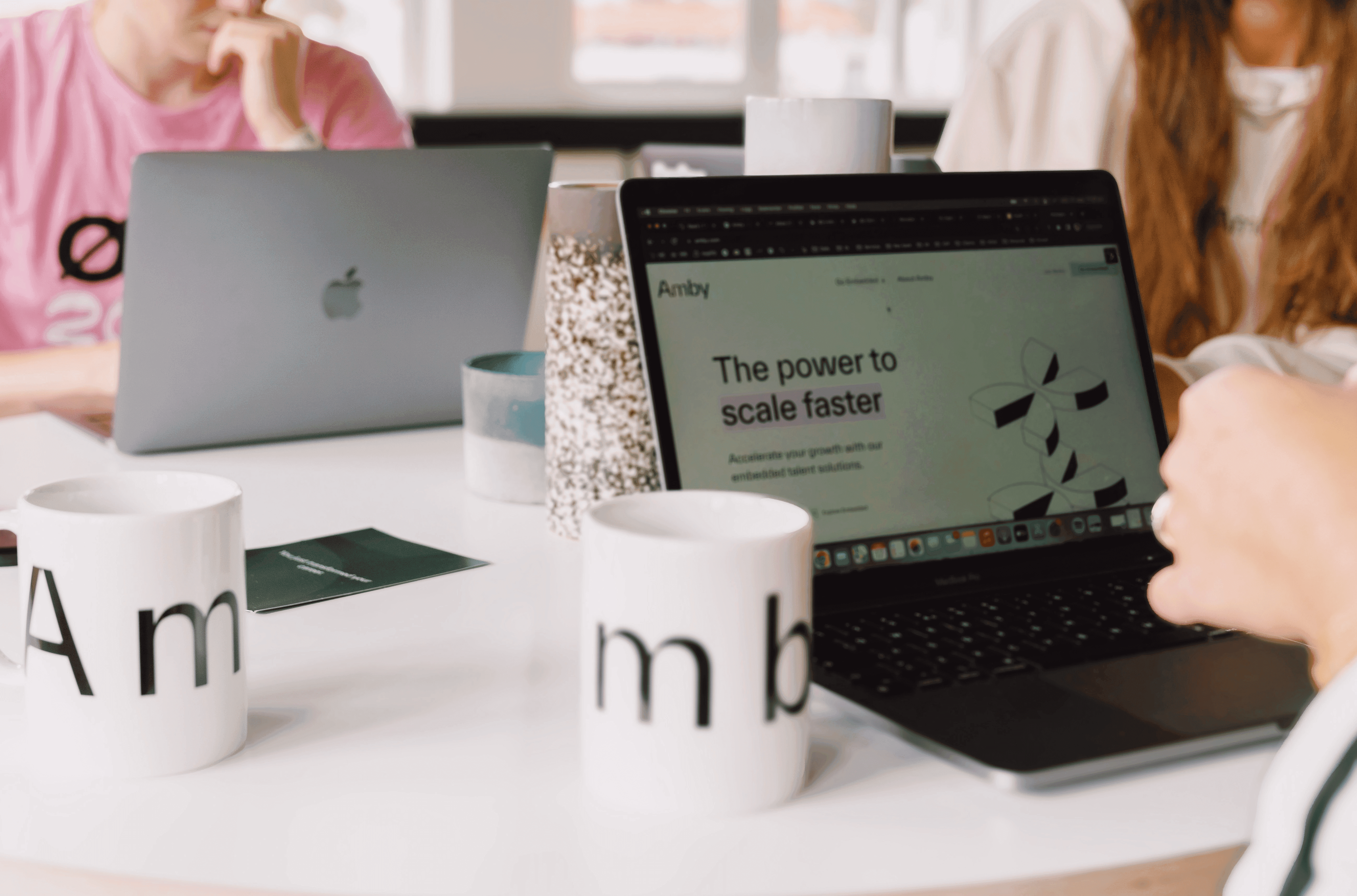 Laptops on desk in coworking office setup for recruiters showing modern workspace